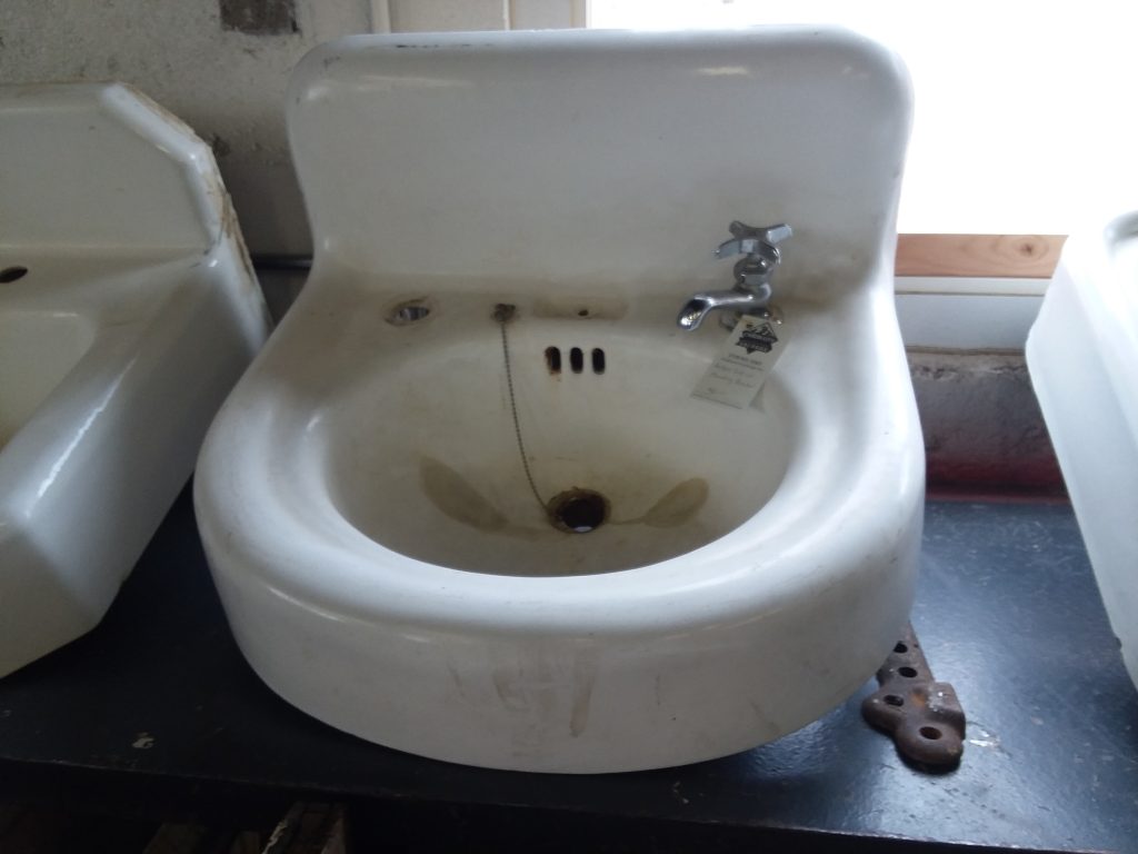 black cast iron bathroom sink with stars embossed